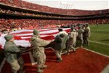 Service members present flag at Arrowhead Stadium